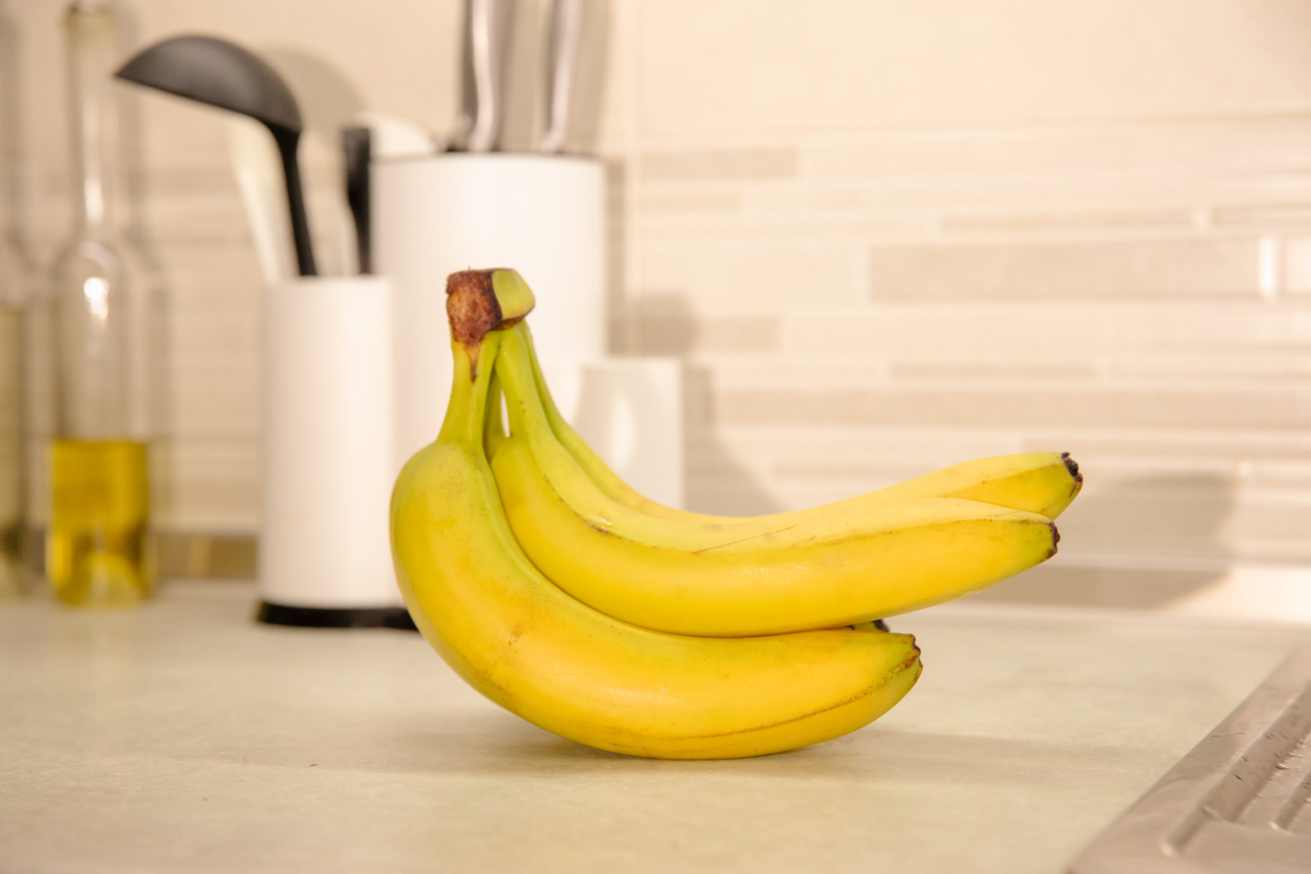 ripe bananas on a table: colorful and healthy fruit stock photography