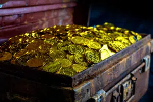 stacking gold coin in treasure chest